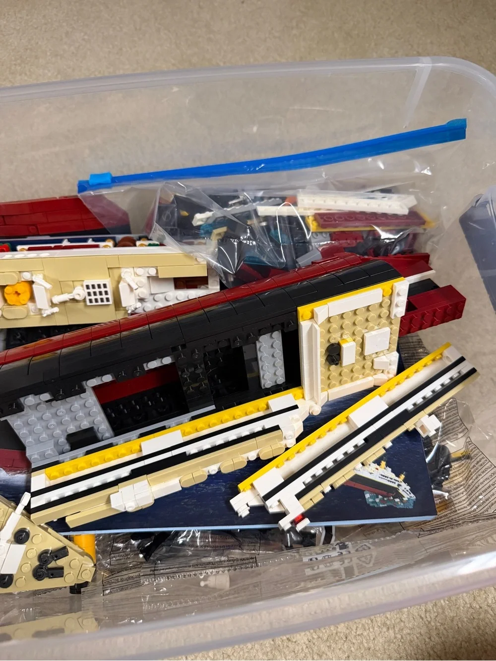 Assorted Lego Ship Hull Pieces in Red, Black, White, Yellow, Tan